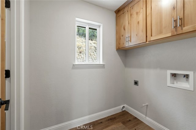 clothes washing area with hookup for a washing machine, cabinets, hardwood / wood-style floors, and hookup for an electric dryer