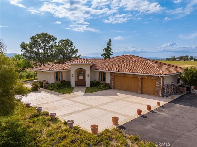 mediterranean / spanish-style house featuring a garage