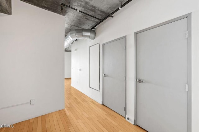 corridor with light hardwood / wood-style floors