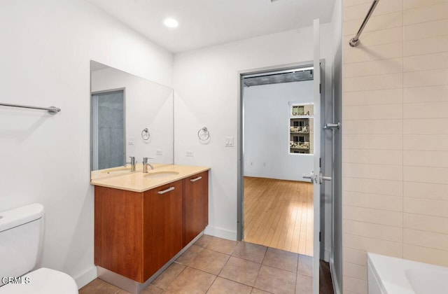 full bathroom with hardwood / wood-style flooring, vanity,  shower combination, and toilet