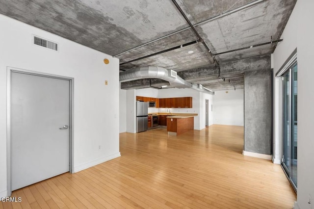 empty room featuring light hardwood / wood-style flooring and sink