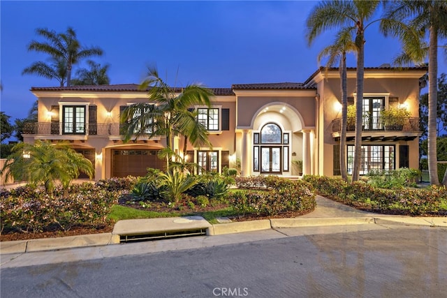 mediterranean / spanish-style house with a balcony and a garage