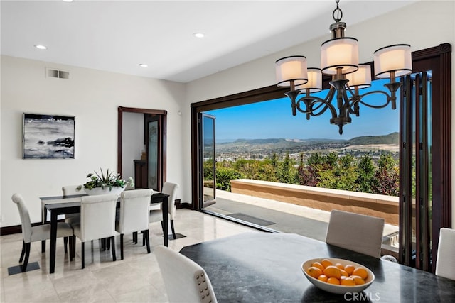 dining area featuring an inviting chandelier and a mountain view