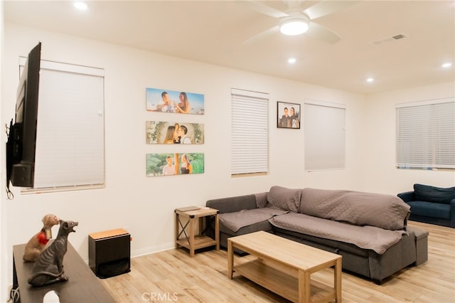 living room featuring light wood-type flooring and ceiling fan