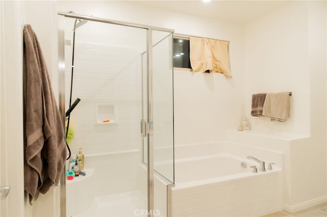 bathroom featuring shower with separate bathtub