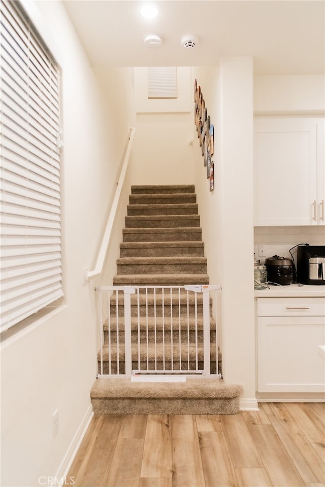 stairway featuring hardwood / wood-style floors