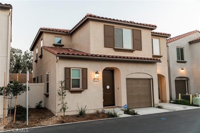 mediterranean / spanish-style home with a garage