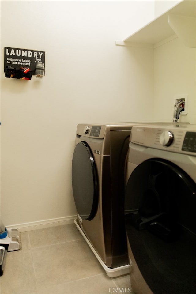 washroom with washer hookup and light tile patterned floors