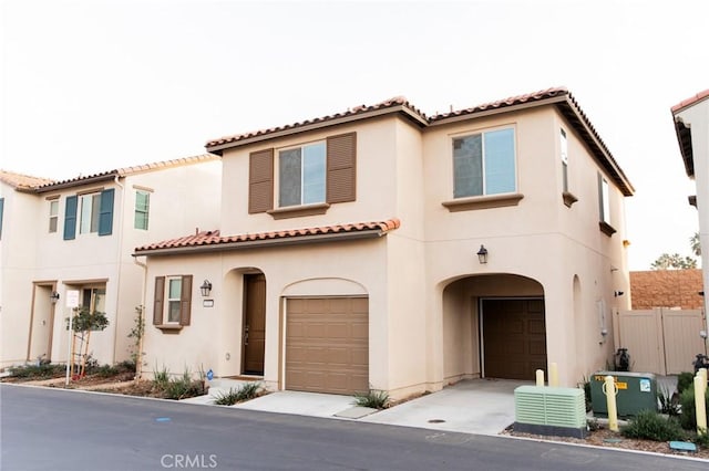 mediterranean / spanish home with a garage and central air condition unit