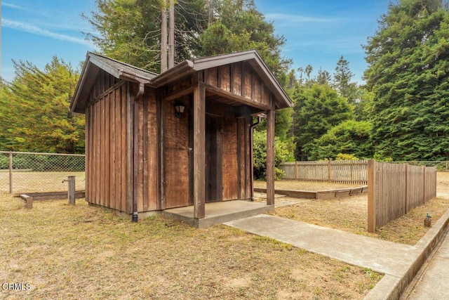 view of shed with fence