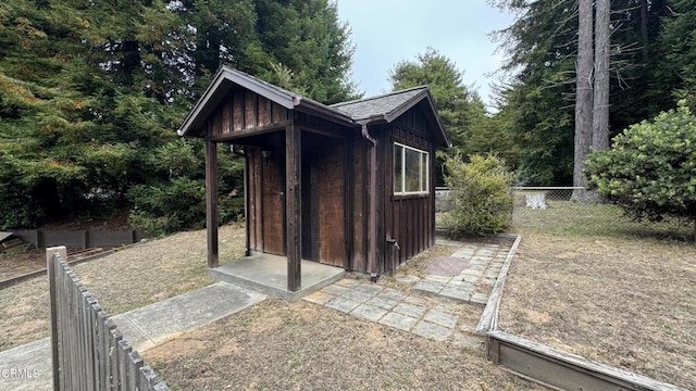 view of shed featuring fence