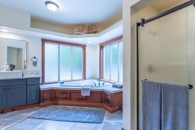 full bath featuring a stall shower, a bath, and vanity