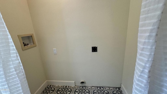 laundry area with tile patterned flooring, hookup for a washing machine, hookup for an electric dryer, laundry area, and baseboards