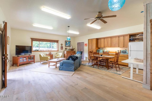 living room with light wood-type flooring and a ceiling fan