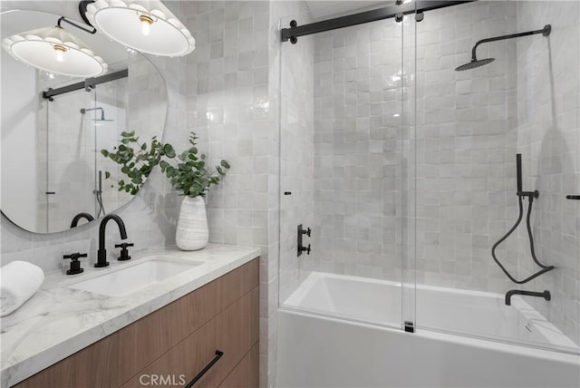 full bathroom featuring tasteful backsplash, vanity, and shower / bath combination with glass door