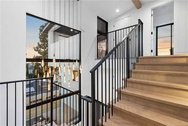 stairs featuring beam ceiling and recessed lighting