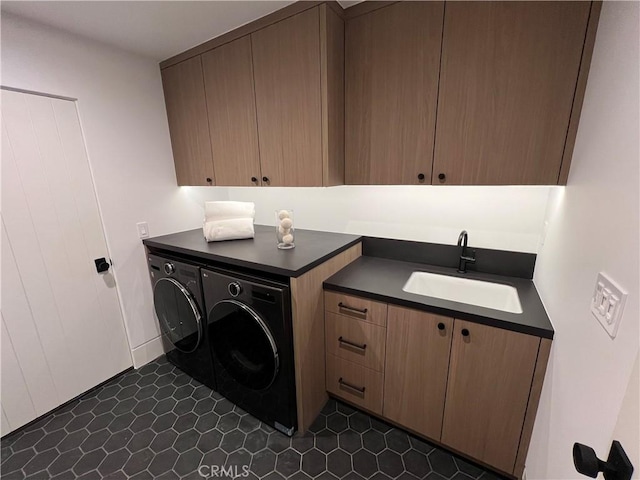 laundry room with washer and clothes dryer, cabinet space, and a sink