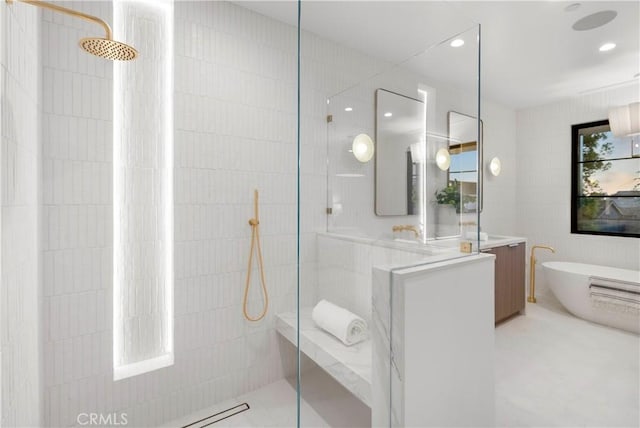 full bathroom featuring recessed lighting, a freestanding tub, walk in shower, and vanity