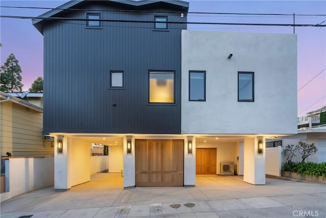 rear view of house featuring washer / dryer and stucco siding