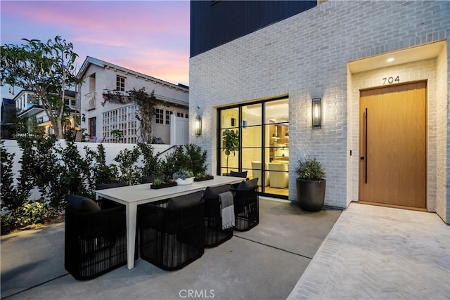 patio terrace at dusk with outdoor dining space