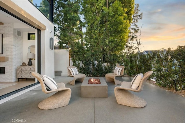 view of patio featuring an outdoor living space with a fire pit