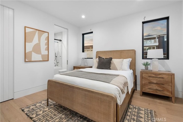 bedroom with recessed lighting, light wood-style flooring, and baseboards