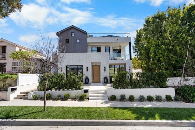 contemporary house with a balcony and fence