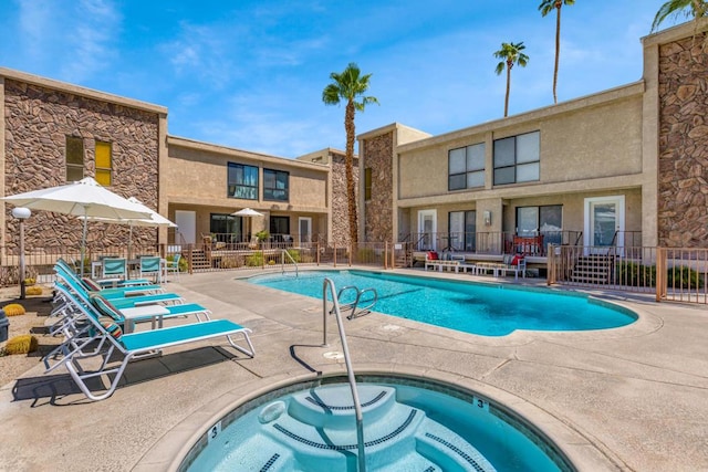 view of swimming pool featuring a patio area and a community hot tub