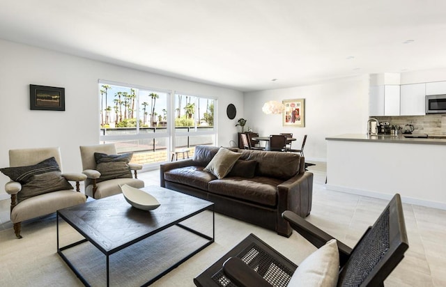 living room with light tile patterned floors and sink