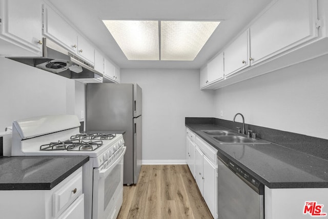 kitchen with dishwasher, white cabinets, sink, and gas range gas stove