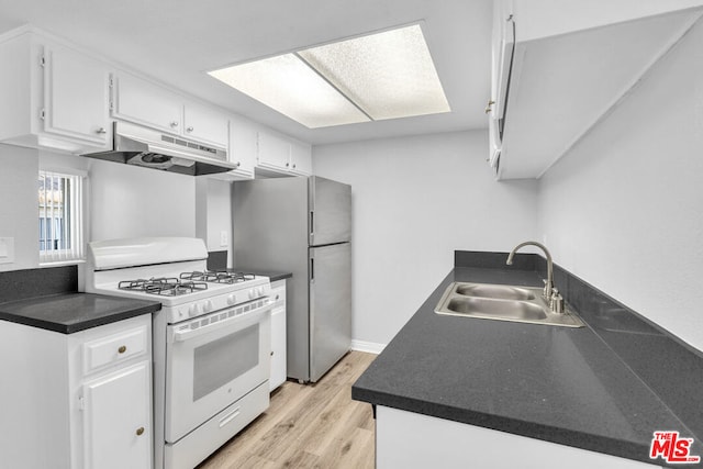 kitchen featuring white cabinets, sink, light hardwood / wood-style flooring, stainless steel refrigerator, and white range with gas cooktop