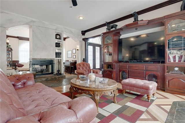 living room featuring decorative columns and ornamental molding