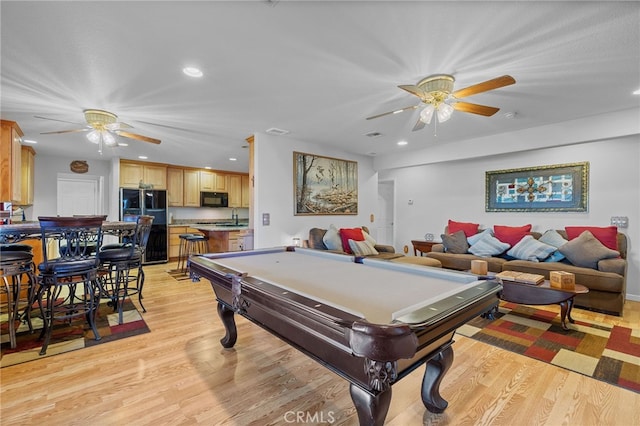 game room with light hardwood / wood-style flooring, pool table, ceiling fan, and sink