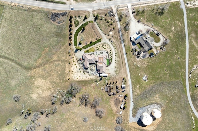 birds eye view of property with a rural view