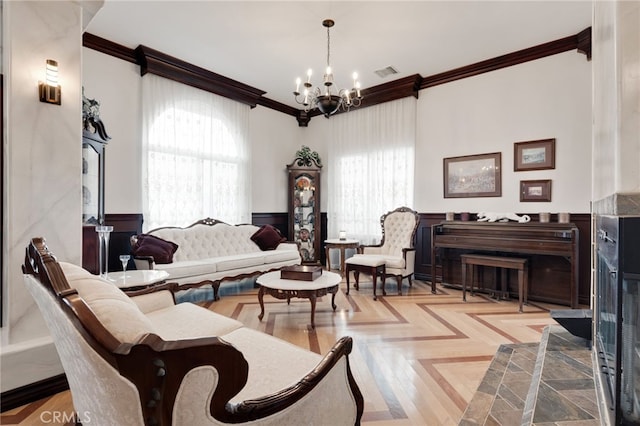 living room featuring a notable chandelier, ornamental molding, and a wealth of natural light