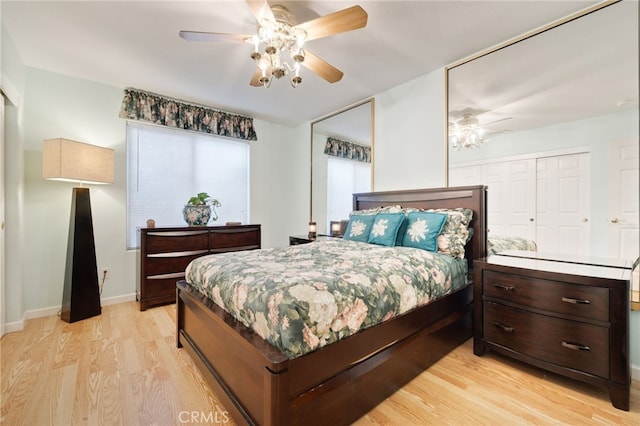 bedroom featuring light hardwood / wood-style floors, ceiling fan, and a closet