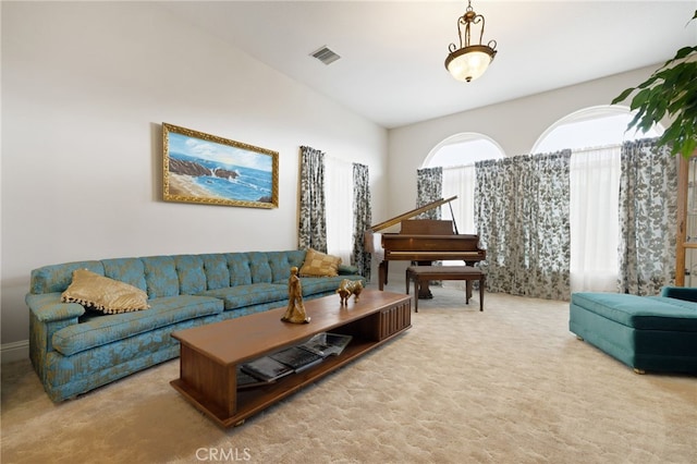 carpeted living room with lofted ceiling