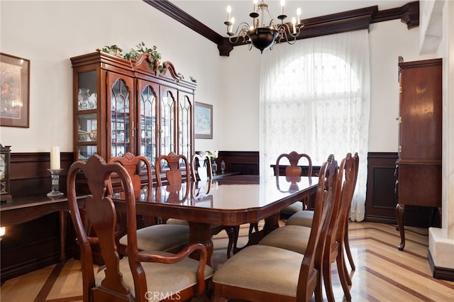 dining room with a notable chandelier and ornamental molding