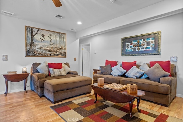 living room with light wood-type flooring and ceiling fan