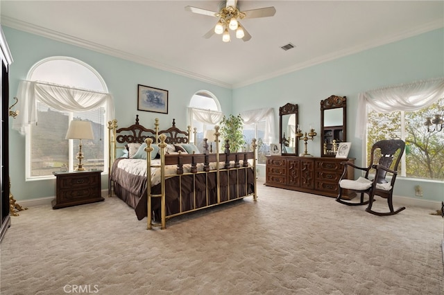 bedroom featuring ceiling fan, light colored carpet, and multiple windows