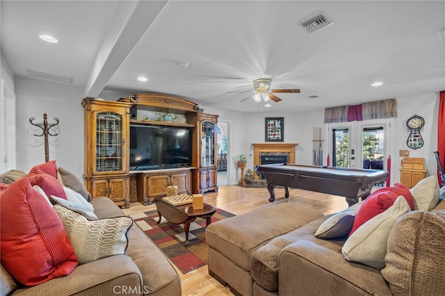 living room with beamed ceiling, light hardwood / wood-style flooring, billiards, ceiling fan, and french doors