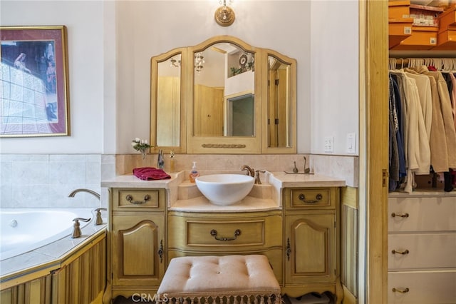 bathroom with vanity and a tub