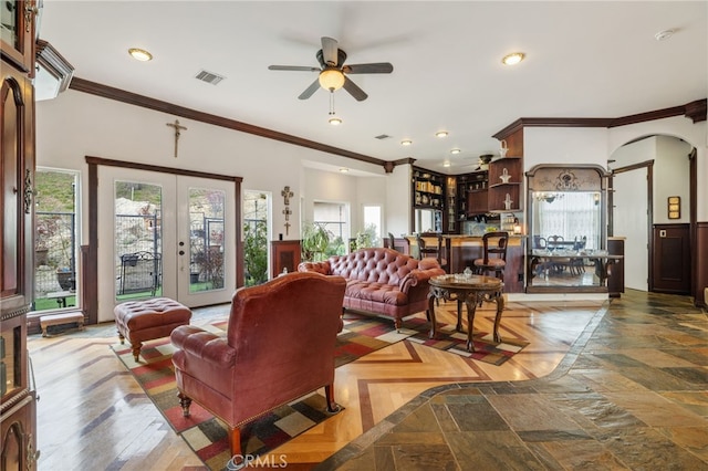 living room featuring ornamental molding, ceiling fan, and french doors