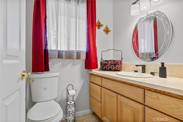 bathroom featuring vanity, tile patterned flooring, and toilet