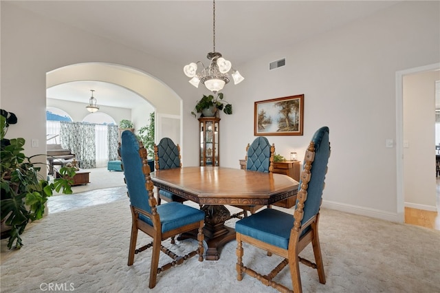 dining room featuring an inviting chandelier and light colored carpet