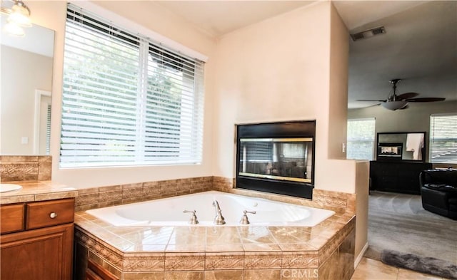 bathroom featuring vanity, ceiling fan, and a wealth of natural light