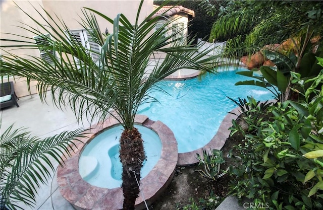 view of swimming pool featuring an in ground hot tub