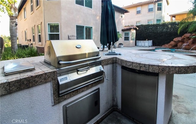 view of patio / terrace featuring sink and exterior kitchen