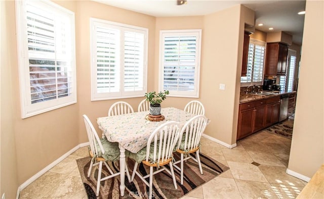 tiled dining room featuring sink