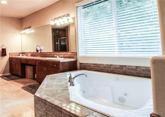 bathroom with shower with separate bathtub, vanity, and a healthy amount of sunlight